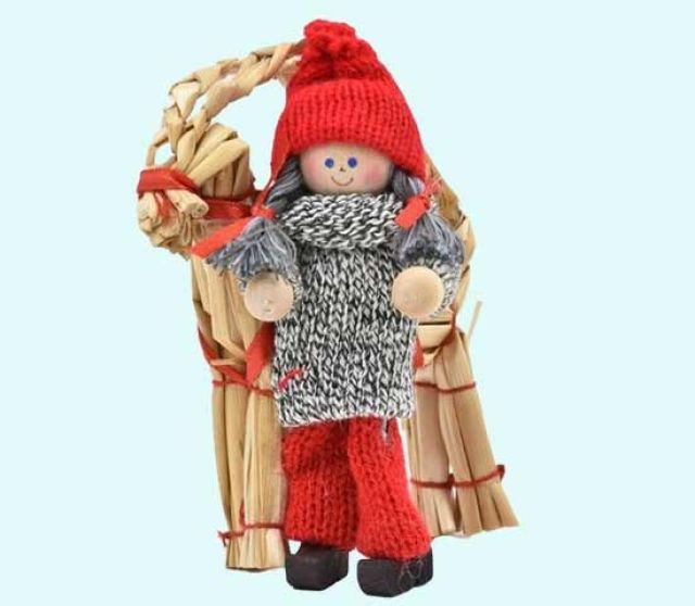 Tomte girl standing w/ straw goat